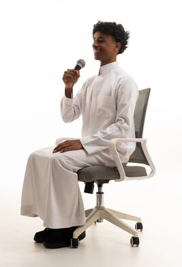 Saudi Man in White Thobe Holding Microphone