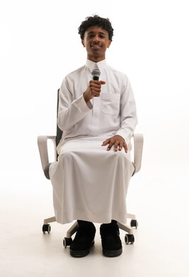 Saudi Man in Thobe Holding Microphone in Studio