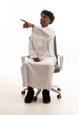 Saudi Man in White Thobe Pointing on Office Chair