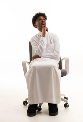 Saudi Man in Thobe Thinking on Office Chair