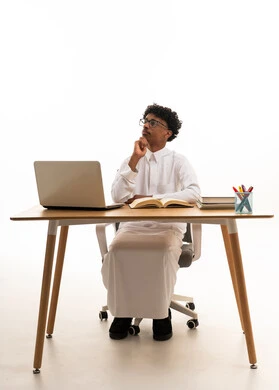 Young Saudi Man Studying with Laptop at Desk