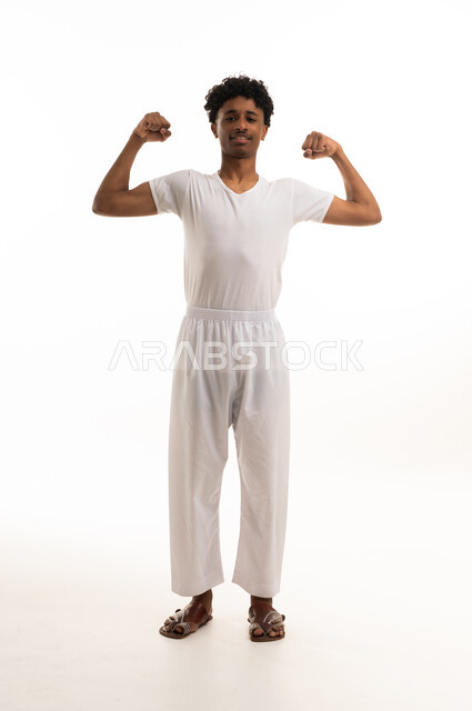 Saudi Man Flexing Muscles in White Studio