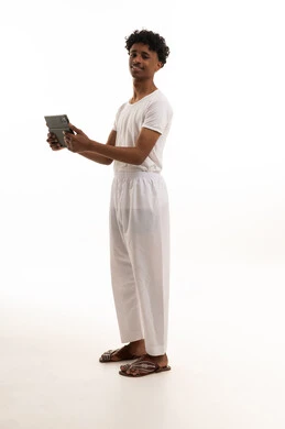Saudi Man Holding Tablet in Traditional Undergarments
