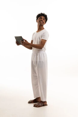 Saudi Man Wearing White Undergarments Holding Tablet