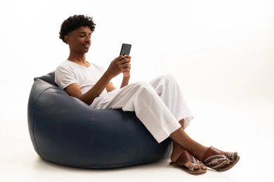 Saudi Man on Bean Bag Using Smartphone in Studio