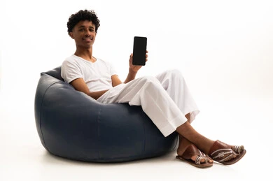 Saudi Man Sitting in Beanbag Holding Smartphone