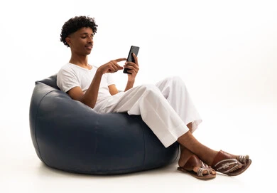 Saudi Man Using Smartphone on Bean Bag Chair