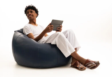 Saudi Man on Bean Bag with Tablet White Background