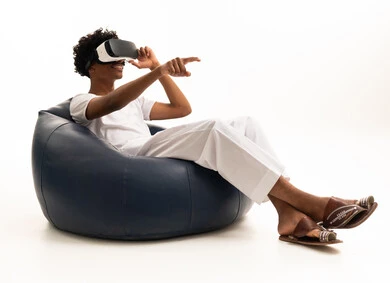 Saudi Man Using VR Headset on Blue Bean Bag