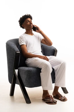 Saudi Man Talking on Smartphone Sitting in Armchair