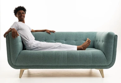 Saudi Man in Traditional Undergarments Lounging on Sofa