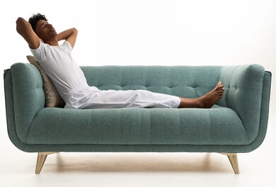 Saudi Man Relaxing on Teal Sofa White Background