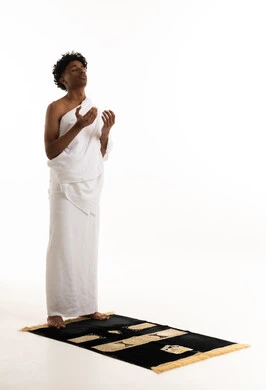 Saudi Man in Ihram Clothes Praying on Rug
