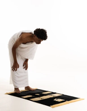 Saudi Man in Ihram Performing Ruku Prayer Position