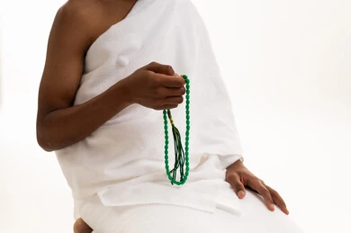 Saudi Man in Ihram Holding Green Prayer Beads