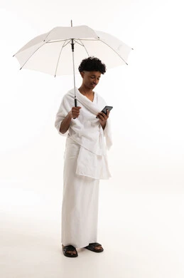 Saudi Man in Ihram with Umbrella and Phone
