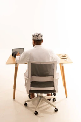 Omani Man Working on Tablet at Minimalist Office Desk