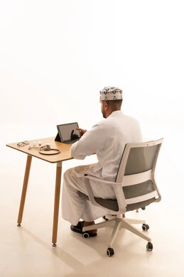 Omani Doctor Using Tablet at Office Desk
