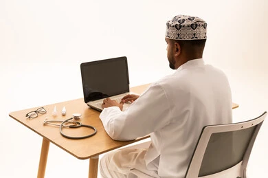 طبيب عُماني يستخدم الحاسوب المحمول في المكتب