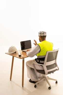 Omani Engineer with Laptop and Safety Vest