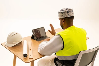 Omani Engineer in Safety Vest Using Tablet