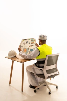 Omani Engineer Reviewing Architectural Floor Plan