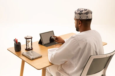 Omani Professional Man Using Digital Tablet at Office Desk