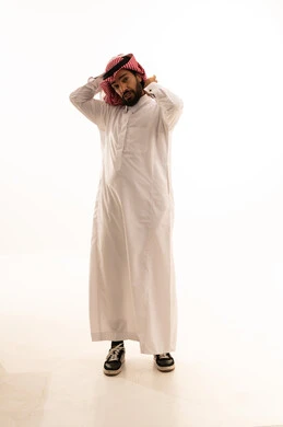 Saudi Man Adjusting Red Shemagh in White Studio