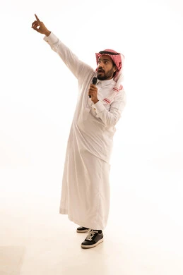 Saudi Man Holding Microphone and Pointing Upward