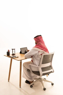 Saudi Man Using Tablet at Office Desk White Background