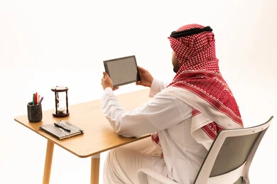 Saudi Man Using Tablet at Office Desk