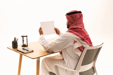 Saudi Man in Traditional Dress Holding Blank Card Mockup