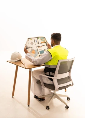 Saudi Engineer Reviewing Floor Plan Blueprint in Studio