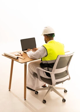 Arab Engineer in Safety Vest Working on Laptop