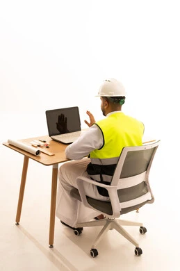 Saudi Engineer in Safety Vest Working on Laptop