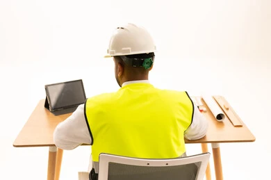 Saudi Engineer in Safety Gear at Office Desk