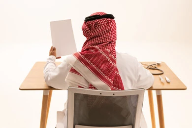 Saudi Male Doctor at Desk Back View