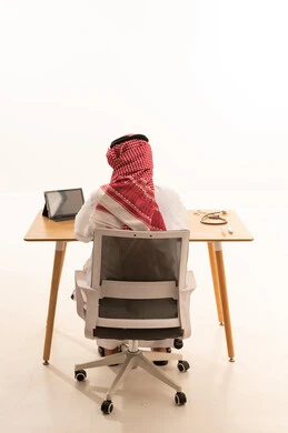 Saudi Male Doctor Working at Desk Back View White Background