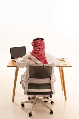 Saudi Doctor Working on Laptop in Office