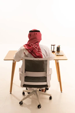 Saudi Businessman Working at Desk Back View