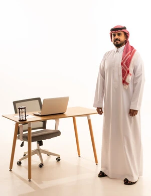 Saudi Businessman Standing by Office Desk in Studio
