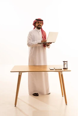Saudi Businessman in Traditional Thobe Holding Laptop