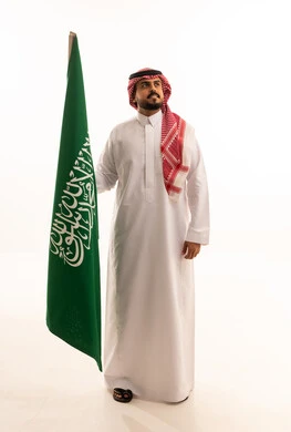 Saudi Man Holding Saudi Arabia Flag on White Background