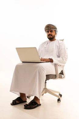 Omani Man with Laptop in Traditional Attire