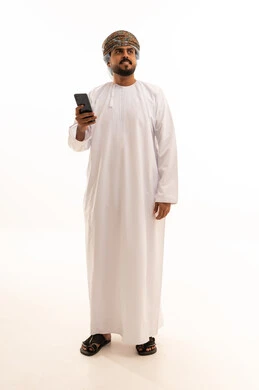 Omani Man in Traditional Dishdasha with Smartphone
