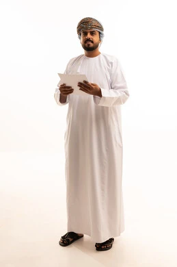 Omani Man in Traditional Dress Holding Documents