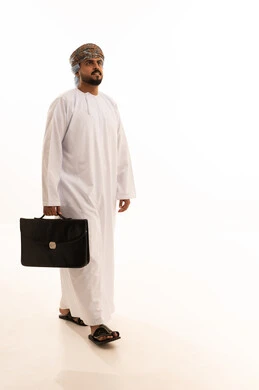 Omani Businessman Walking with Briefcase in Traditional Dress