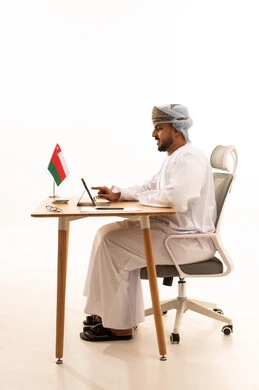Professional Omani Man Using Tablet at Office Desk