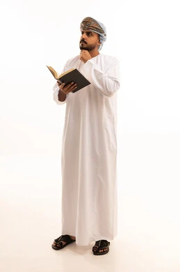Omani Man in Traditional Dress Holding Book