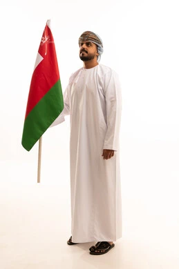 Omani Man Holding National Flag in Traditional Dress